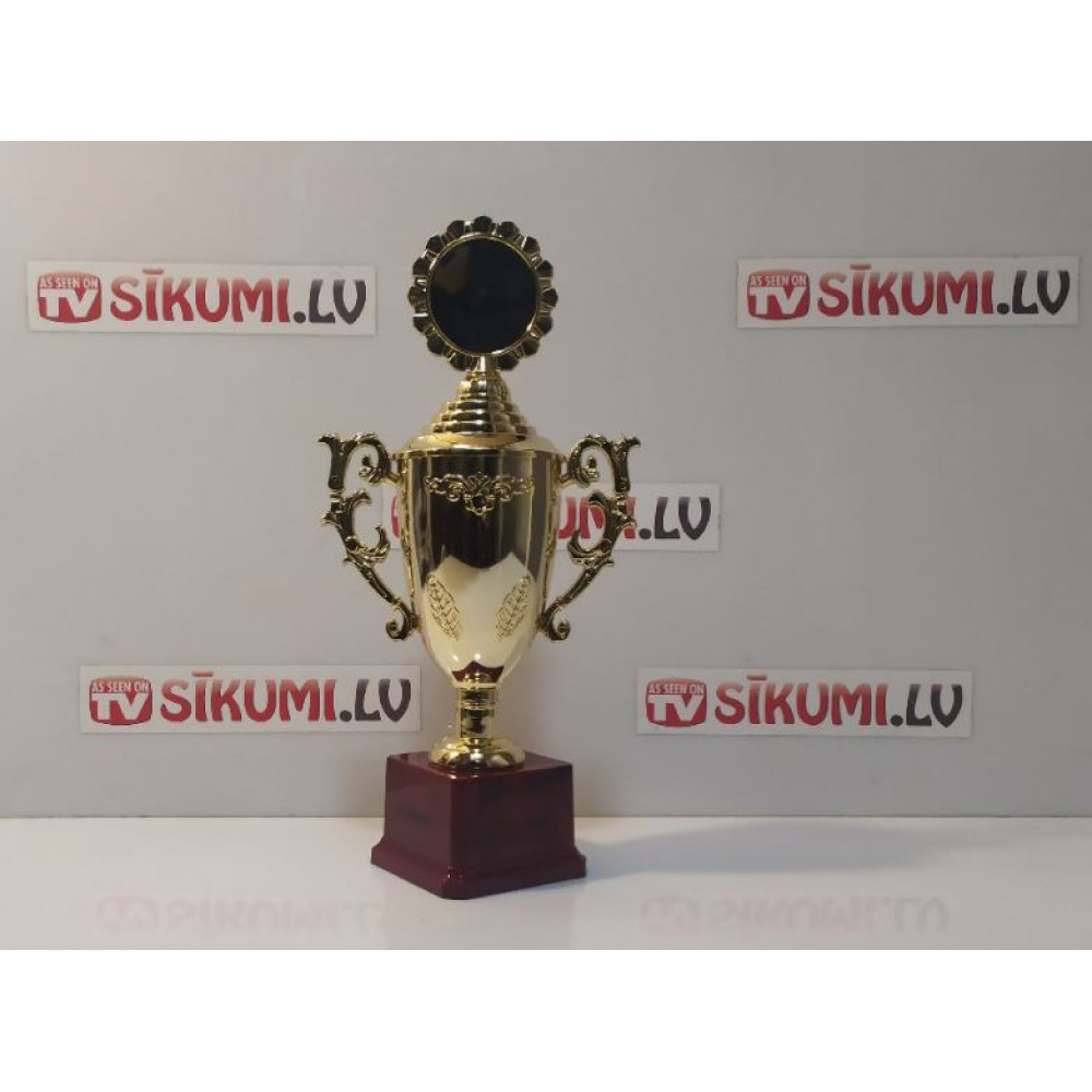 Gift gold trophy winner on a marble stand - an award at sports competitions, corporate events, a gift for an anniversary or birthday