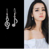 Stylish musical earrings in the form of a treble clef and notes with rhinestones